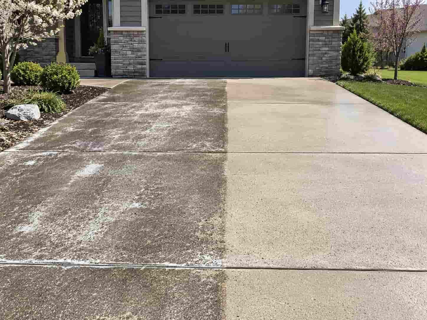 Concrete driveway showing winter salt residue removed by spring power washing